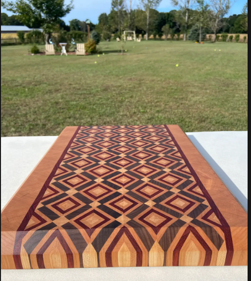 Finished end-grain board at a low angle, showing the diamond field and laminated front edge